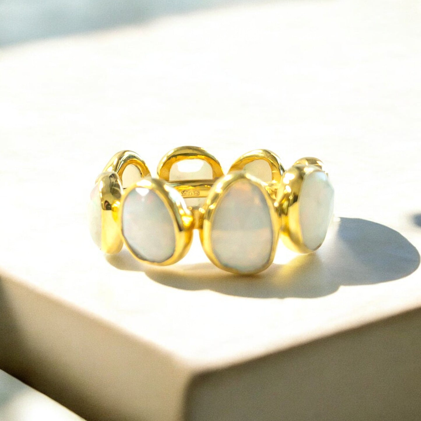 18K yellow gold eternity band ring with oval opals.