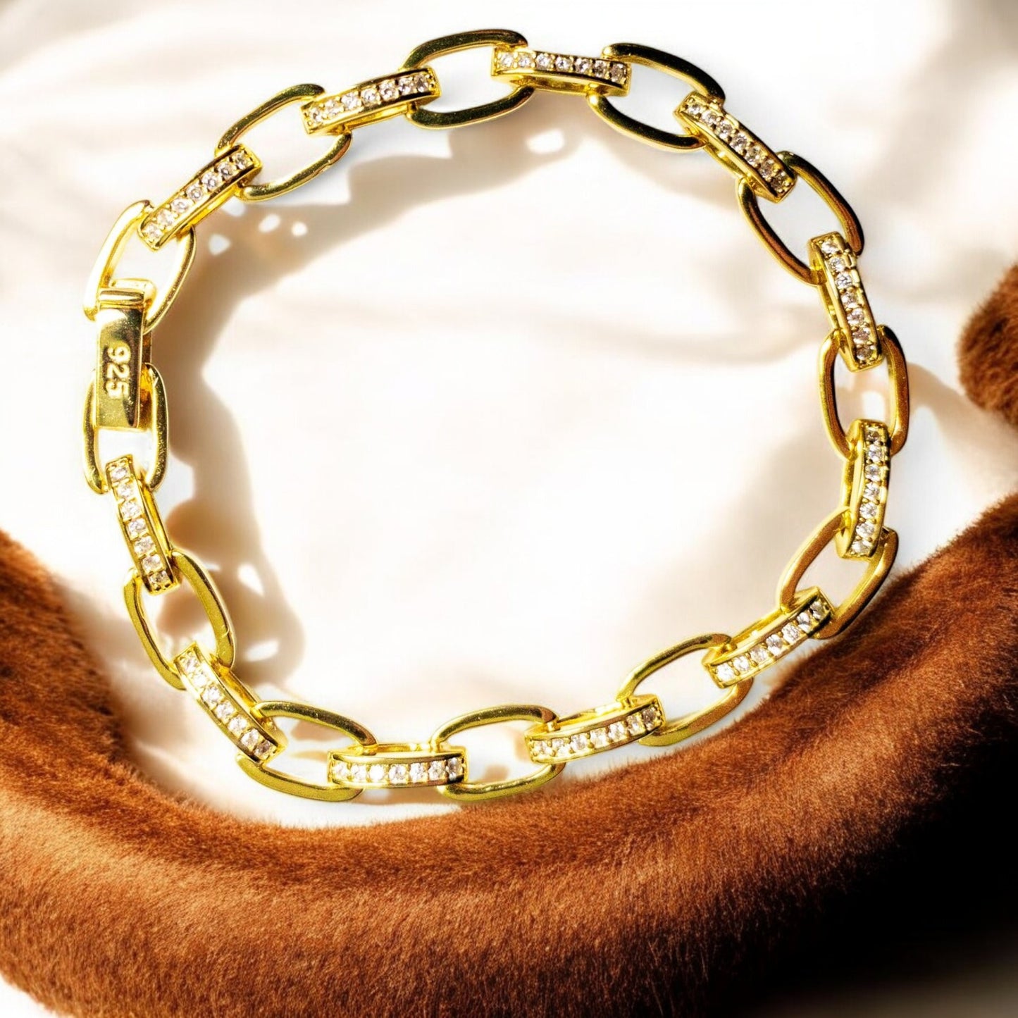 14K gold-plated sterling silver bracelet with cubic zirconia stones and invisible clips.