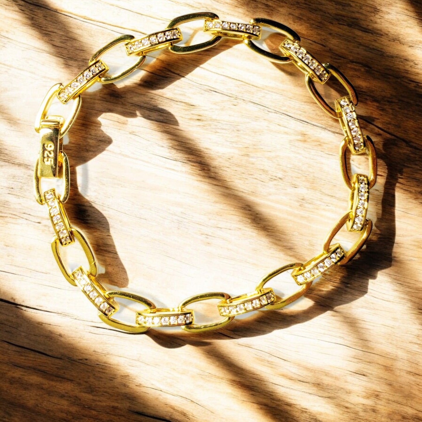 14K gold-plated sterling silver bracelet with cubic zirconia stones and invisible clips.