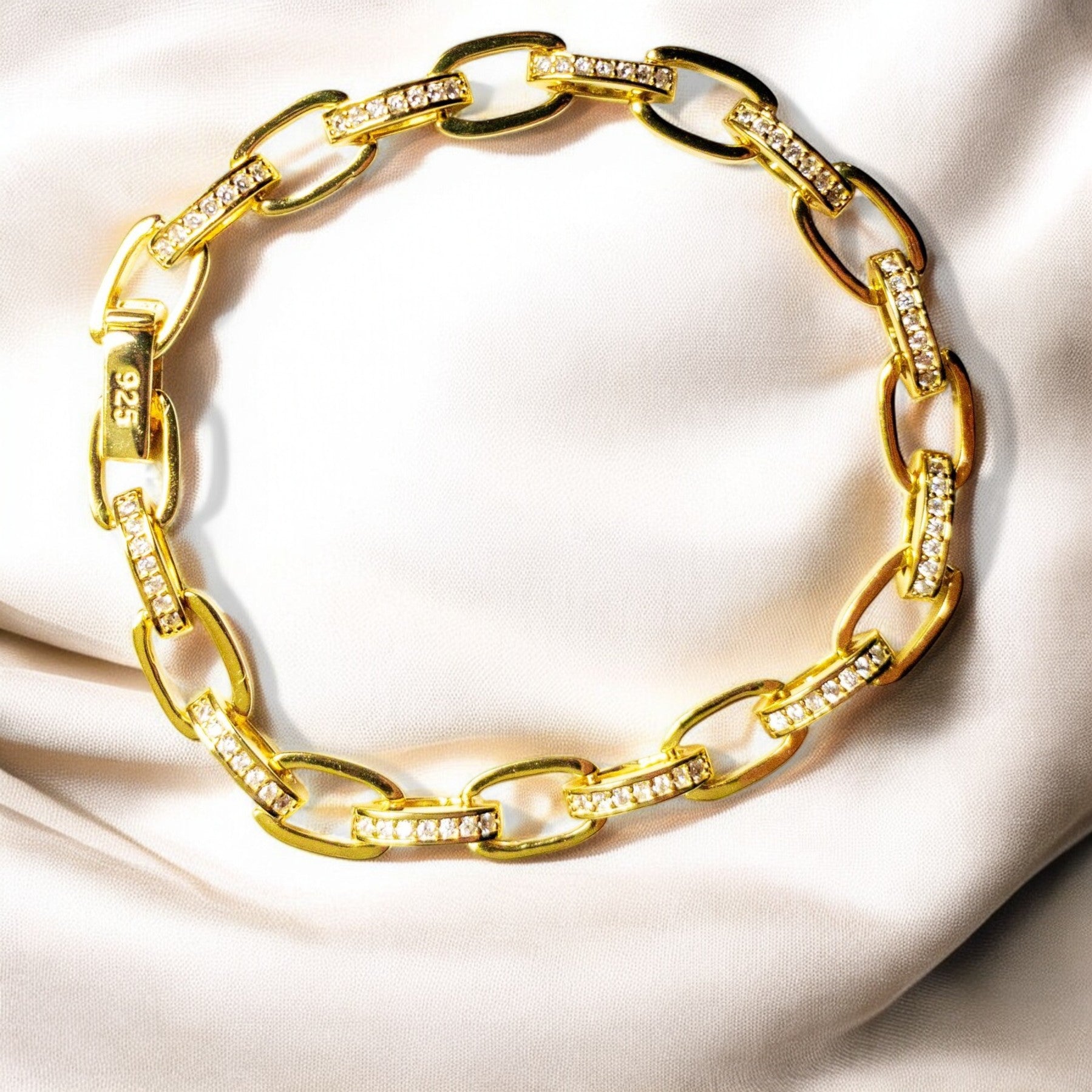 14K gold-plated sterling silver bracelet with cubic zirconia stones and invisible clips.