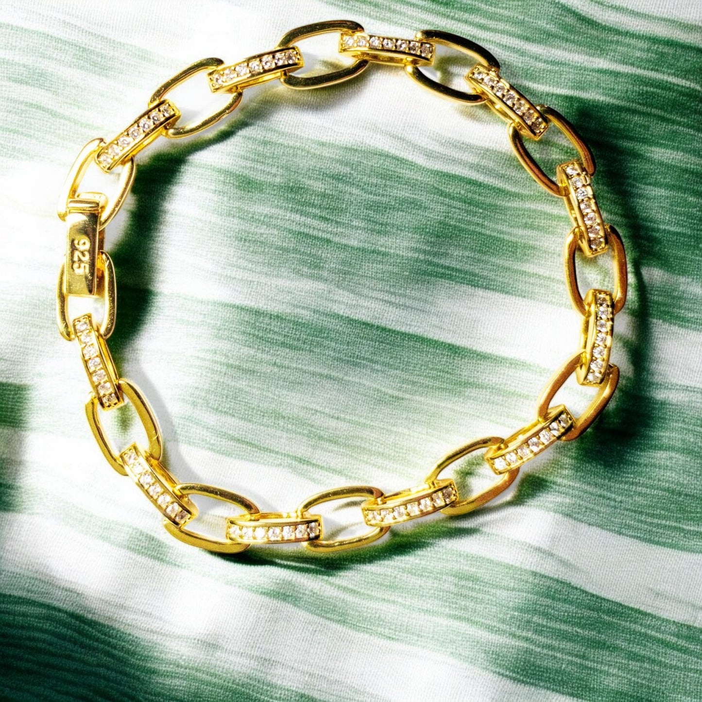 14K gold-plated sterling silver bracelet with cubic zirconia stones and invisible clips.