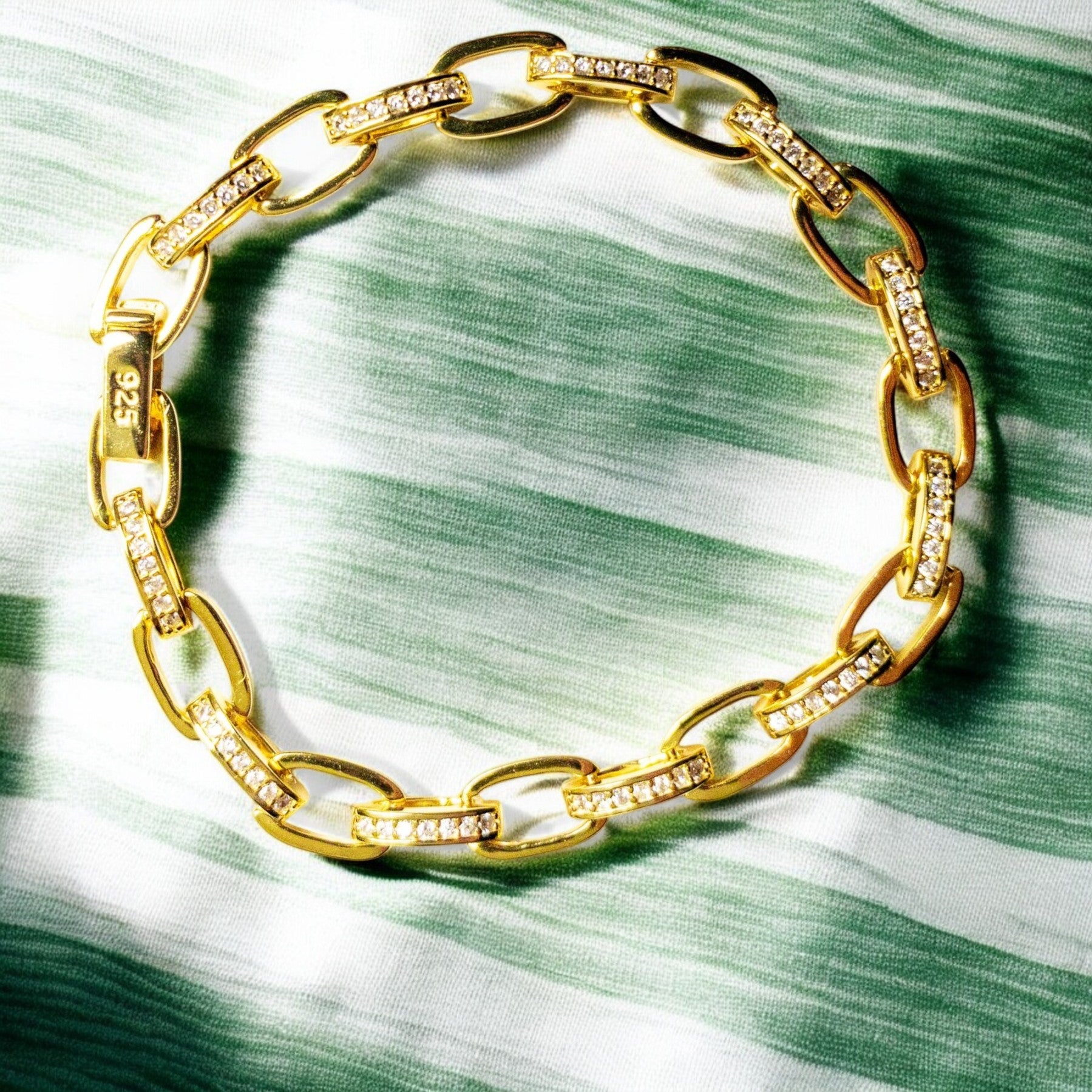 14K gold-plated sterling silver bracelet with cubic zirconia stones and invisible clips.